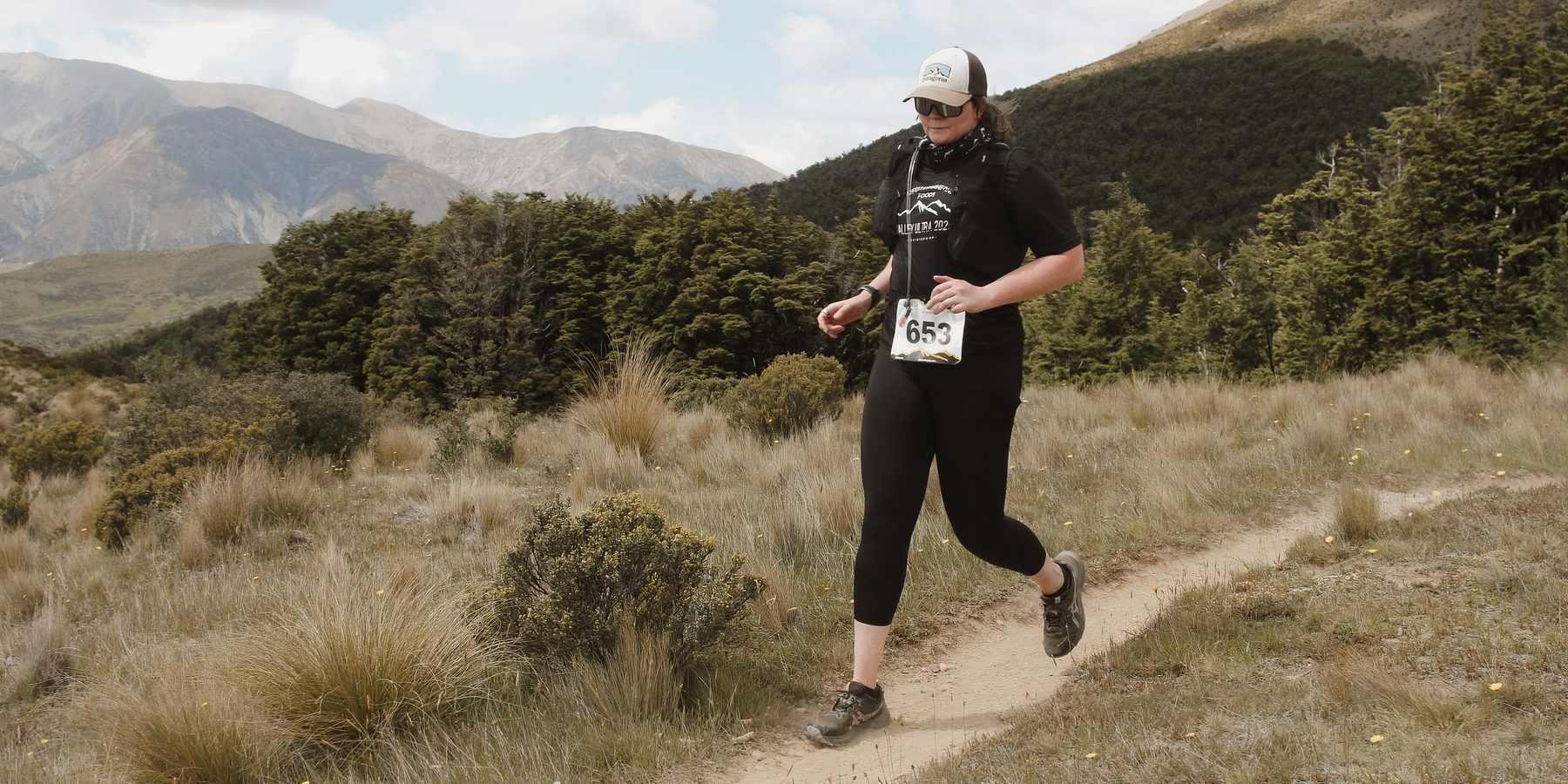 Mikaela trail running in the New Zealand mountains